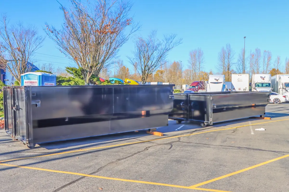 Professional dumpster rental service with roll-off container on residential driveway in Fort Collins